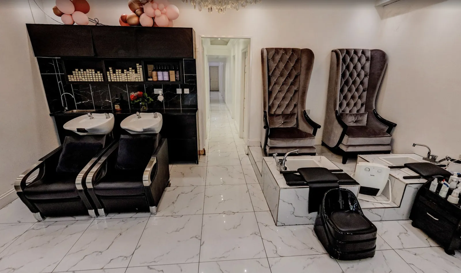 Backwash basins and velvet pedicure chairs, with the corridor to the treatment rooms