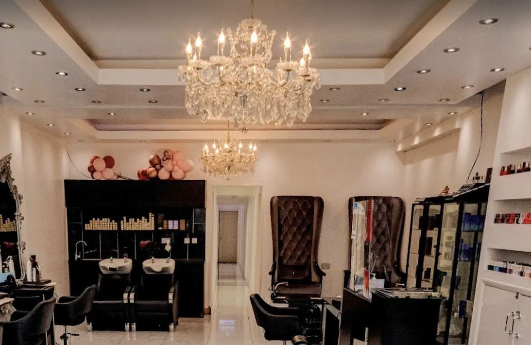 Crystal chandeliers above the backwash basins and velvet pedicure chairs at the back of the salon