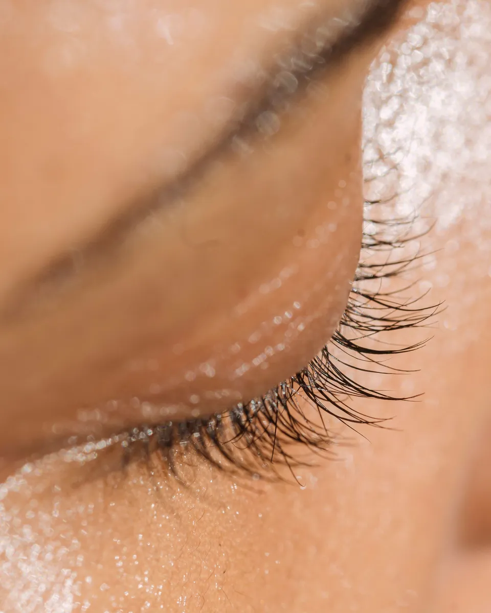 Close-up of a closed eye with long natural lashes